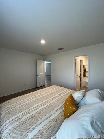 a bedroom with a bed and a mirror