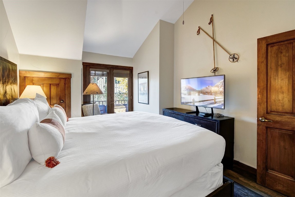 91 River Run Road, Unit 8137 Keystone, CO 80435 - Photo 14 of 37 a bedroom with a bed and a flat screen tv