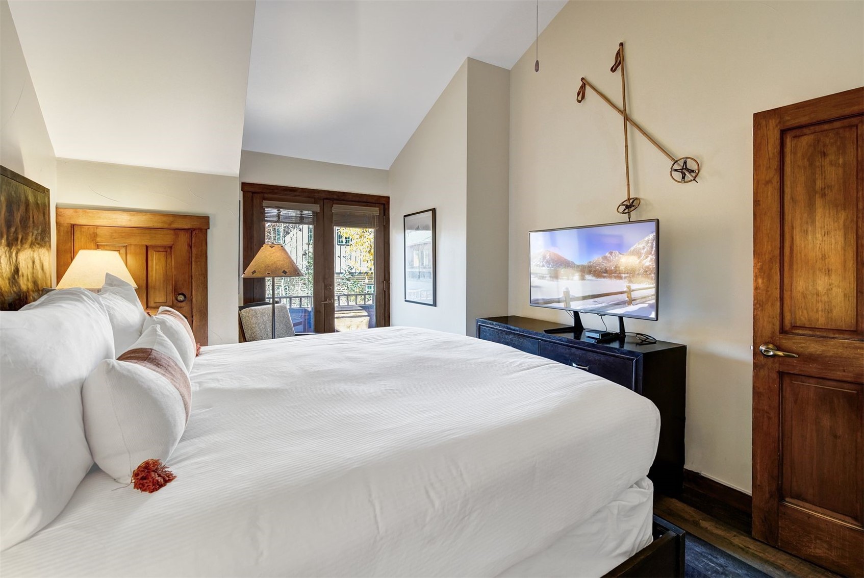 91 River Run Road, Unit 8137 Keystone, CO 80435 - Photo 14 of 37 a bedroom with a bed and a flat screen tv