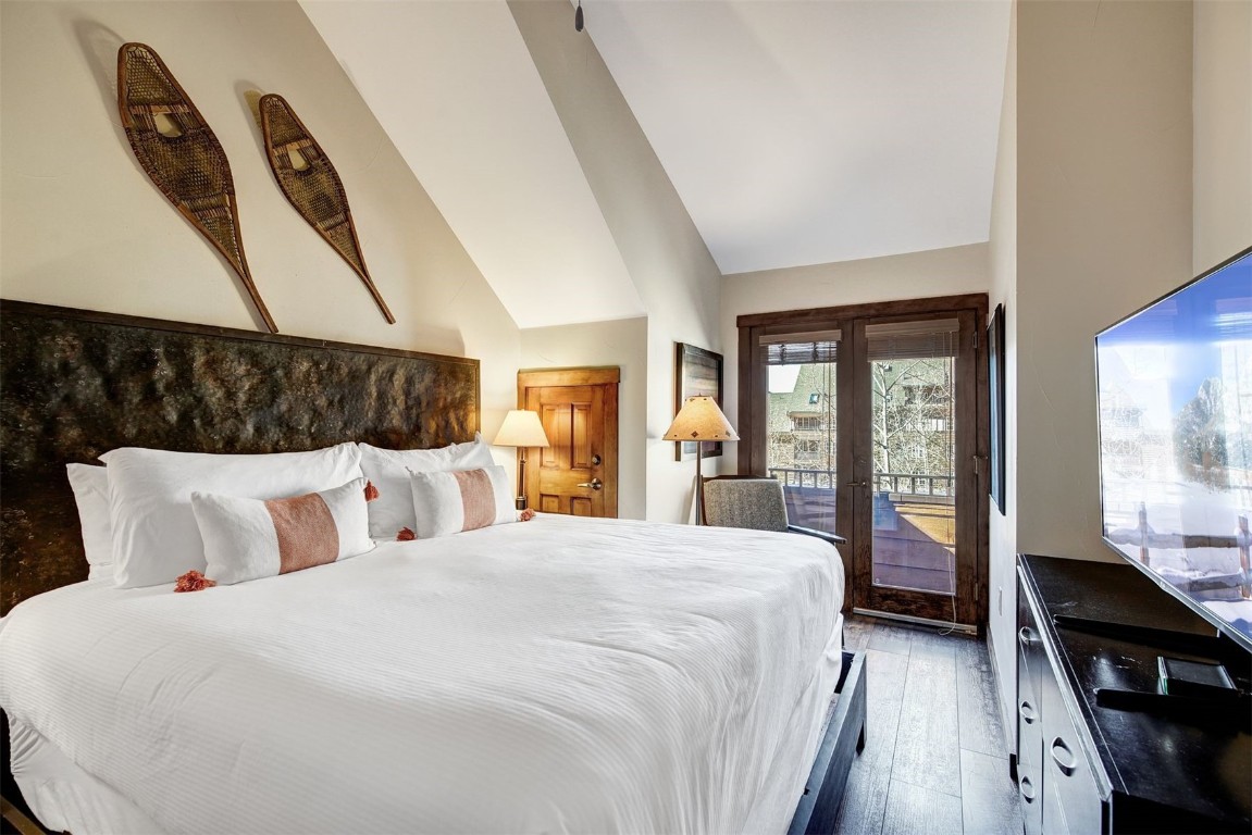 91 River Run Road, Unit 8137 Keystone, CO 80435 - Photo 15 of 37 a bedroom with a large bed and wooden floor