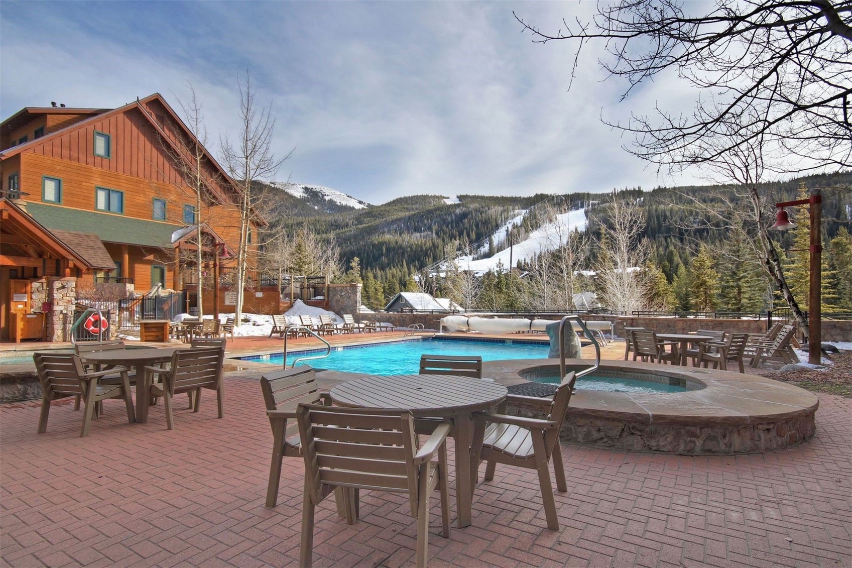 91 River Run Road, Unit 8137 Keystone, CO 80435 - Photo 33 of 37 a view of a patio with dining table and chairs with wooden floor and fence