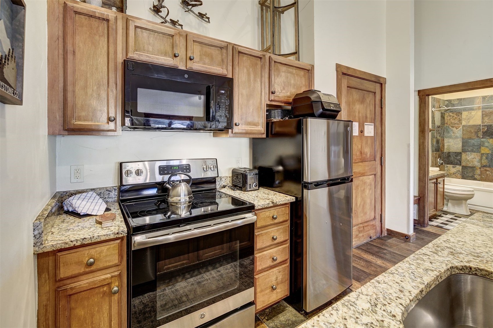 91 River Run Road, Unit 8137 Keystone, CO 80435 - Photo 6 of 37 a kitchen with stainless steel appliances granite countertop a stove refrigerator and microwave