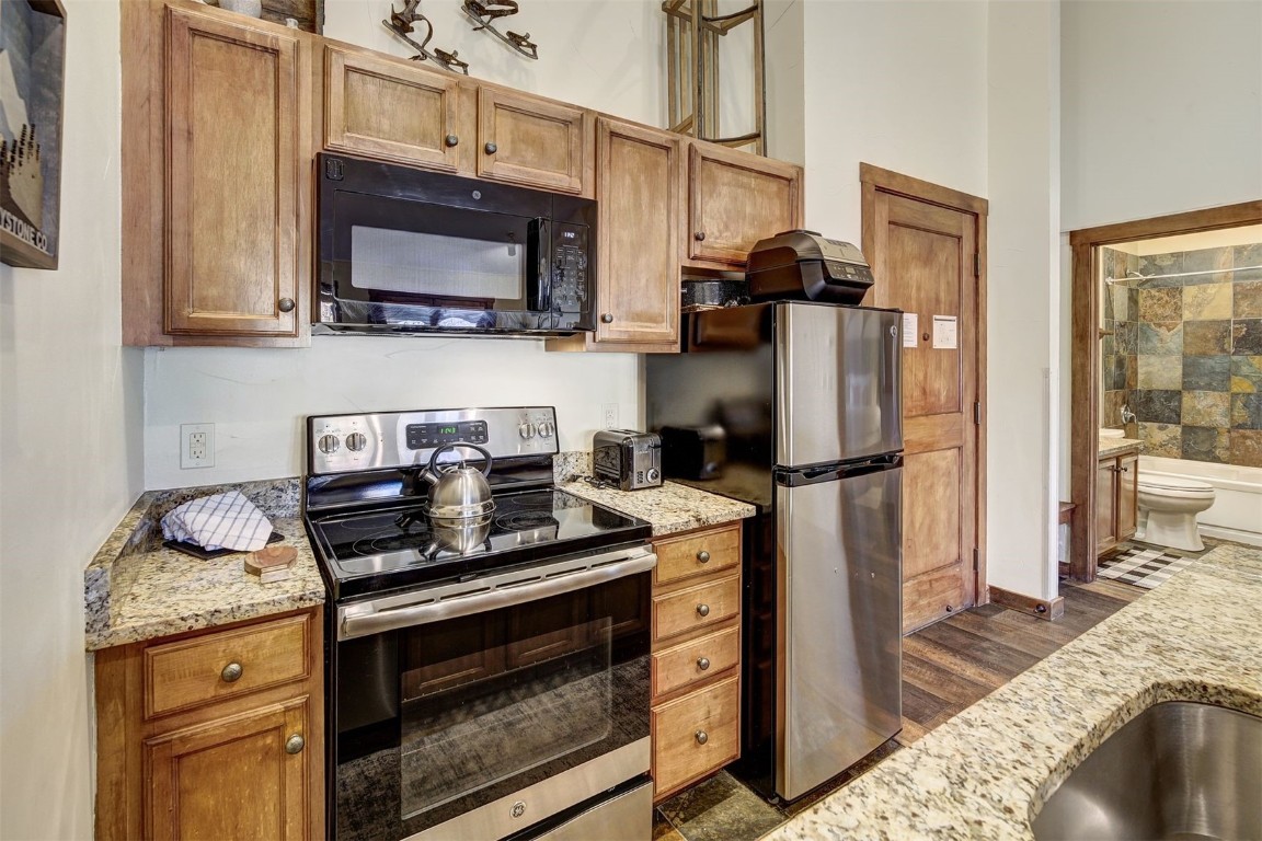 91 River Run Road, Unit 8137 Keystone, CO 80435 - Photo 6 of 37 a kitchen with stainless steel appliances granite countertop a stove refrigerator and microwave