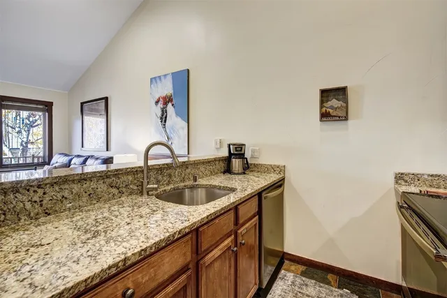 a kitchen with sink and a window