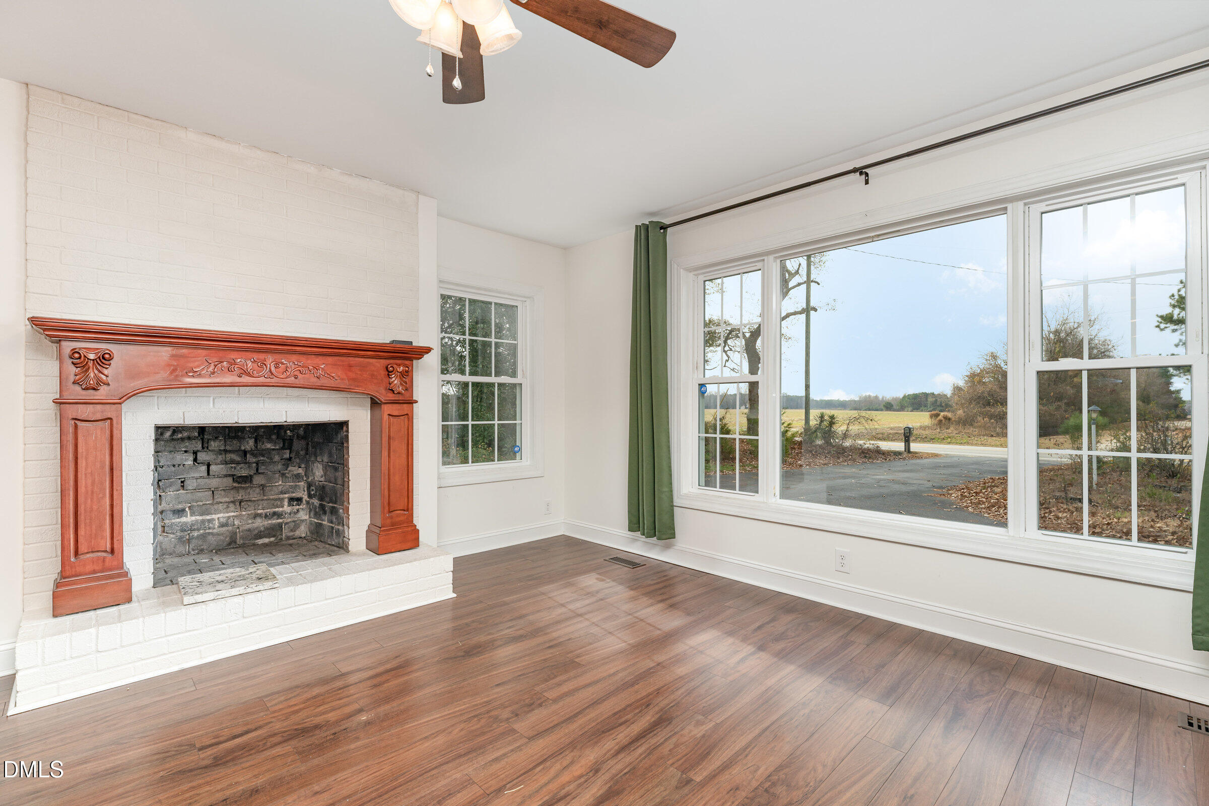 4159 Princeton Kenly Road Kenly, NC 27542 - Photo 14 of 37 a view of an empty room with wooden floor and a window
