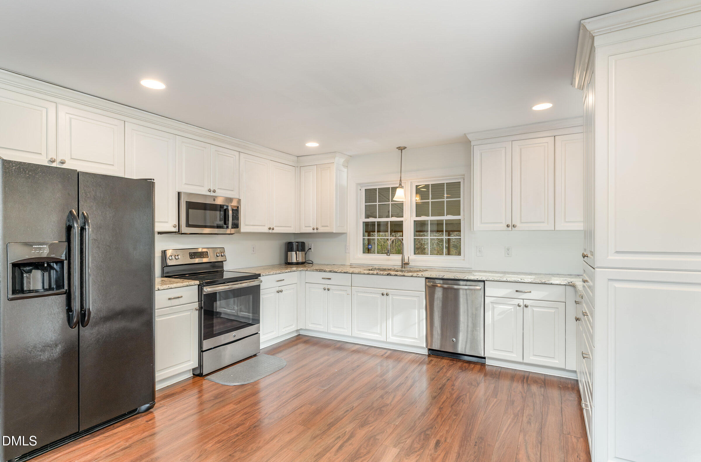 4159 Princeton Kenly Road Kenly, NC 27542 - Photo 15 of 37 a large kitchen with cabinets wooden floor and stainless steel appliances