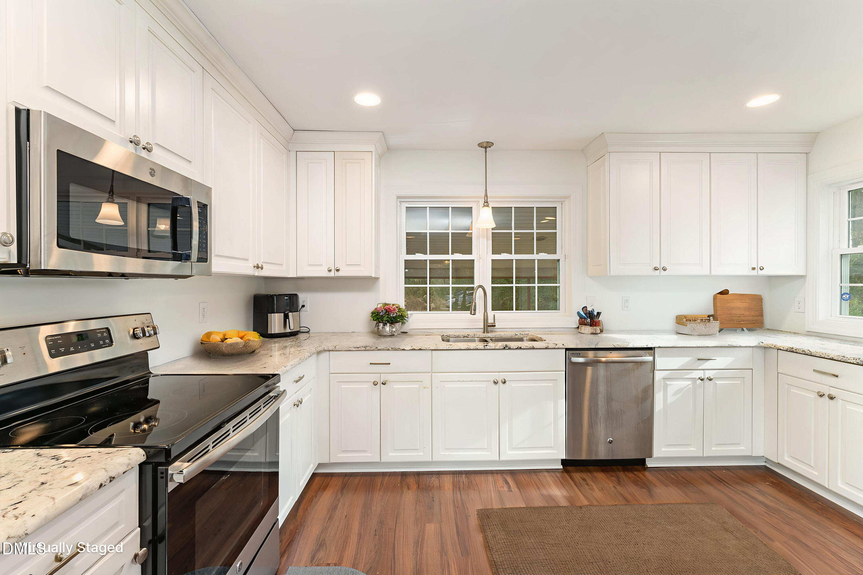 4159 Princeton Kenly Road Kenly, NC 27542 - Photo 16 of 37 a kitchen with stainless steel appliances granite countertop a stove top oven a sink dishwasher and white cabinets with wooden floor
