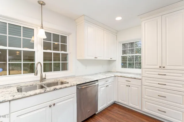 an empty room with wooden floor and ceiling fan