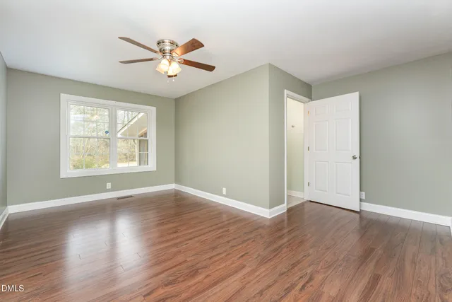 a view of a house with a yard and wooden fence