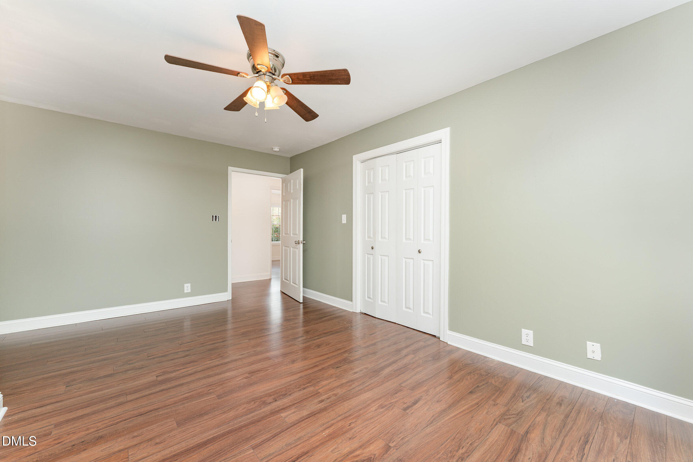 4159 Princeton Kenly Road Kenly, NC 27542 - Photo 23 of 37 a view of an empty room with wooden floor and a ceiling fan