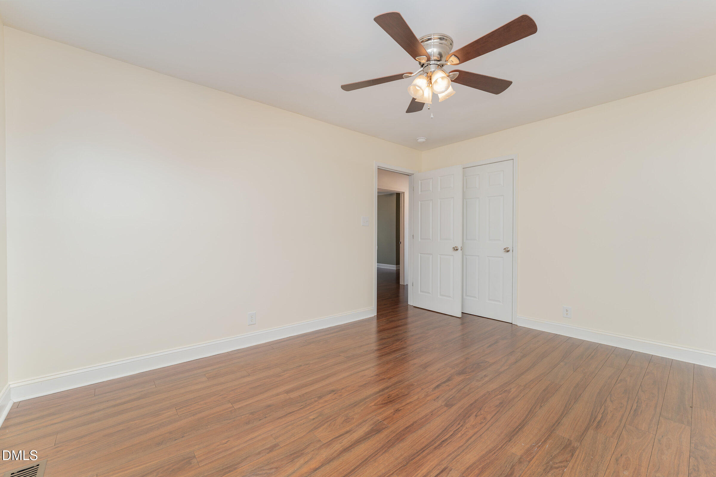 4159 Princeton Kenly Road Kenly, NC 27542 - Photo 27 of 37 an empty room with wooden floor and ceiling fan