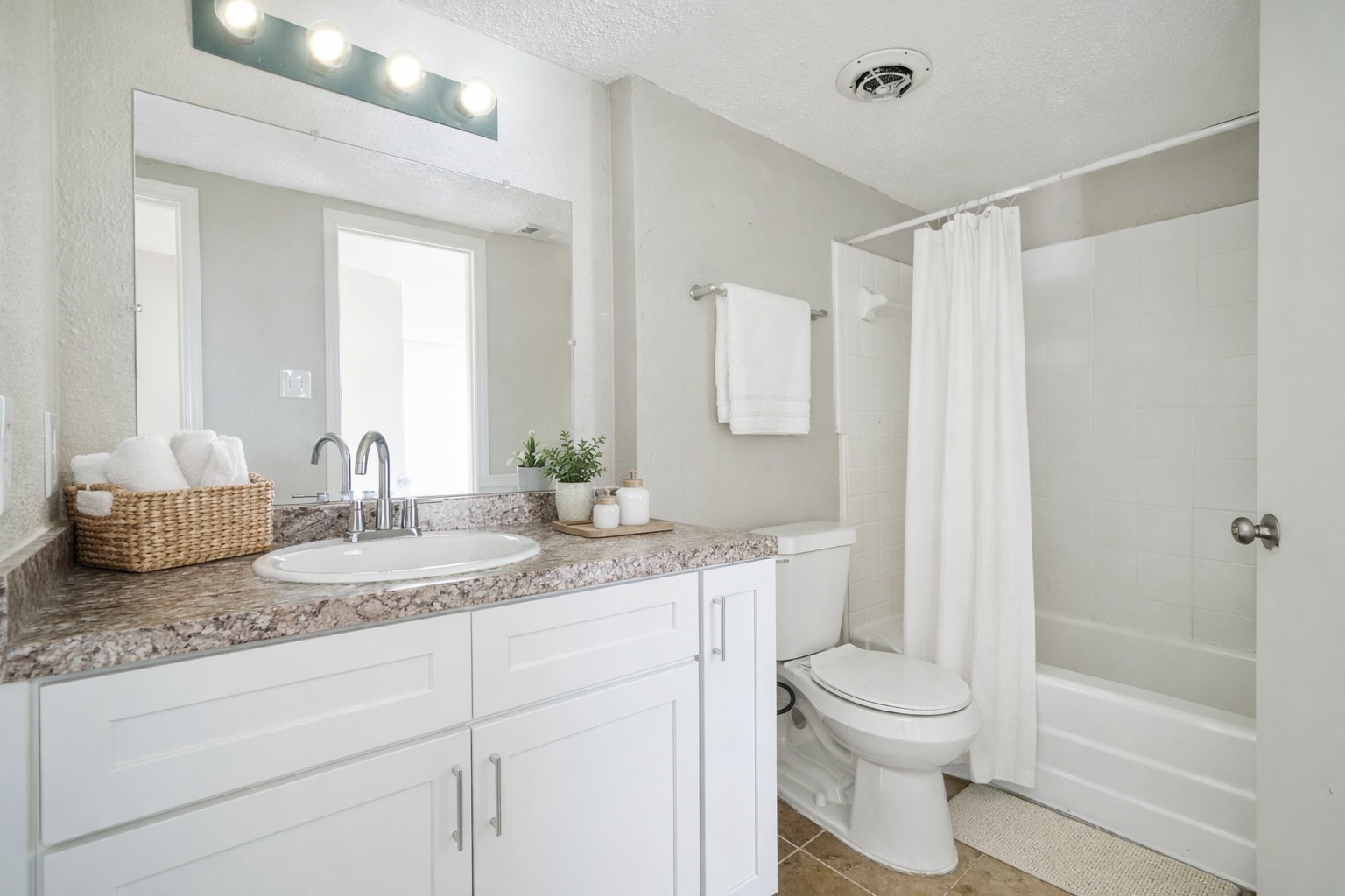 8100 Leonora Street, Unit L5 Houston, TX 77061 - Photo 8 of 11 a bathroom with a granite countertop sink mirror vanity and toilet