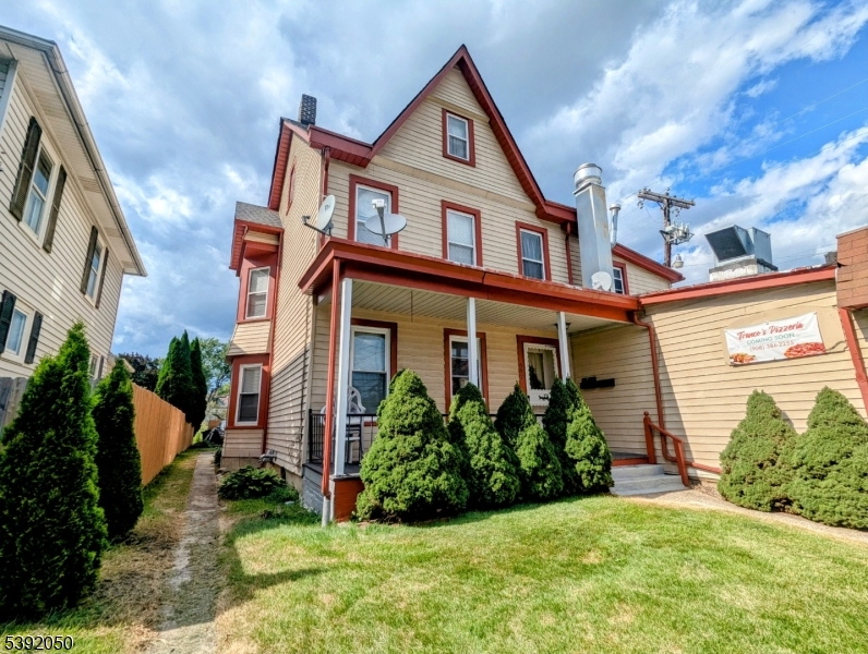 a front view of a house with a yard and plants