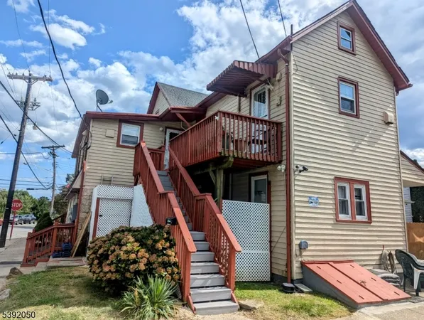 a front view of a house with wooden stairs