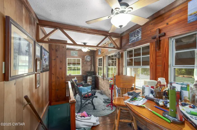 a work room with furniture and floor to ceiling windows