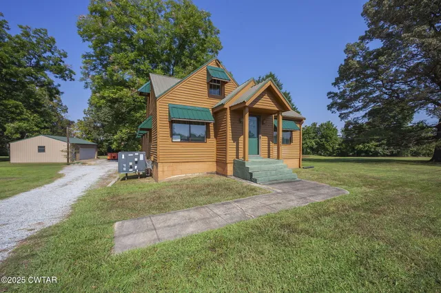 a front view of a house with a yard