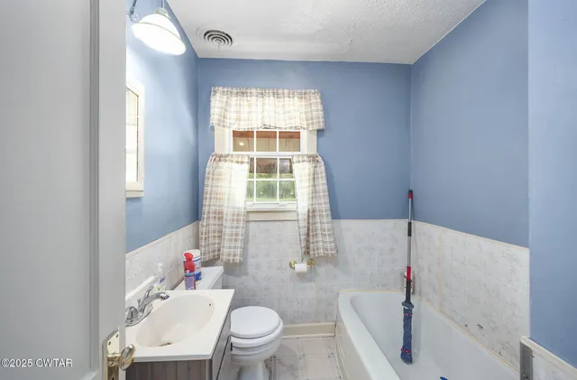 a bathroom with a sink toilet and bathtub