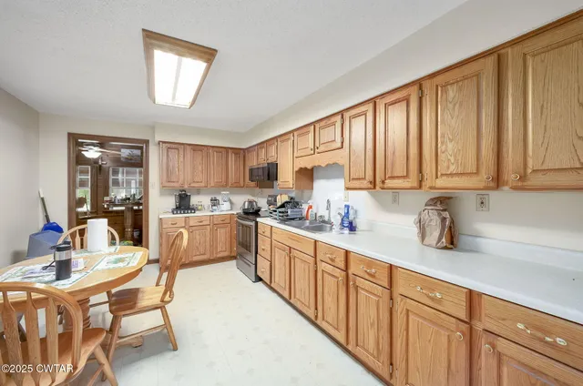a kitchen with stainless steel appliances granite countertop a sink and cabinets