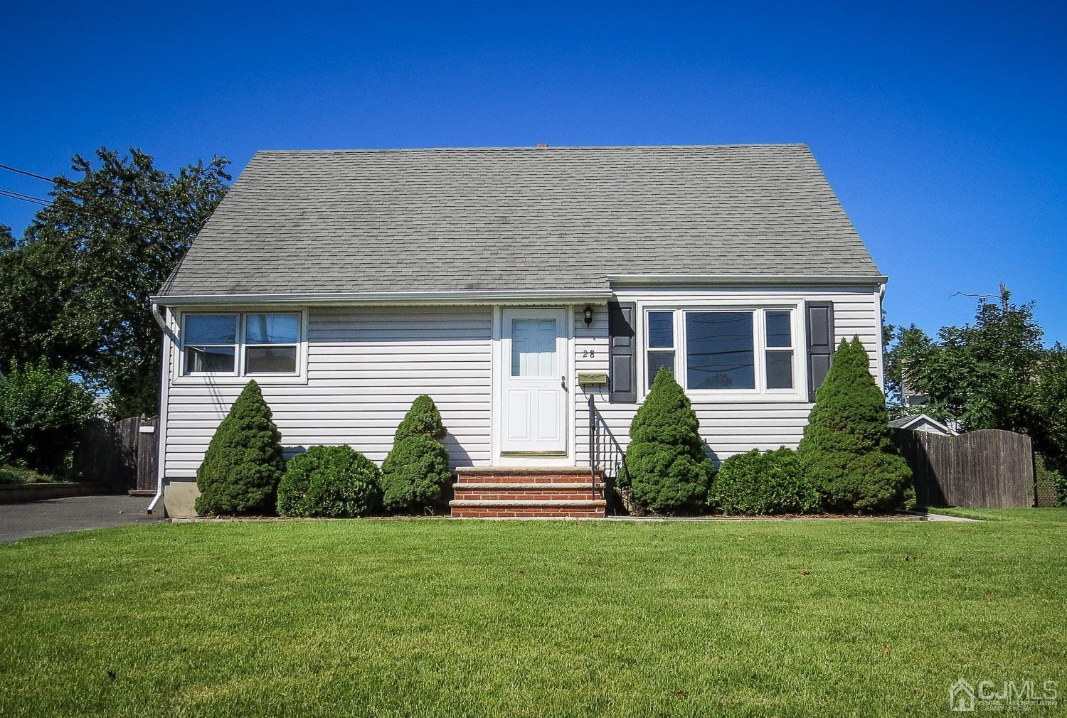28 Longfield Road New Brunswick, NJ 08901 - Photo 2 of 14 a front view of a house with a garden