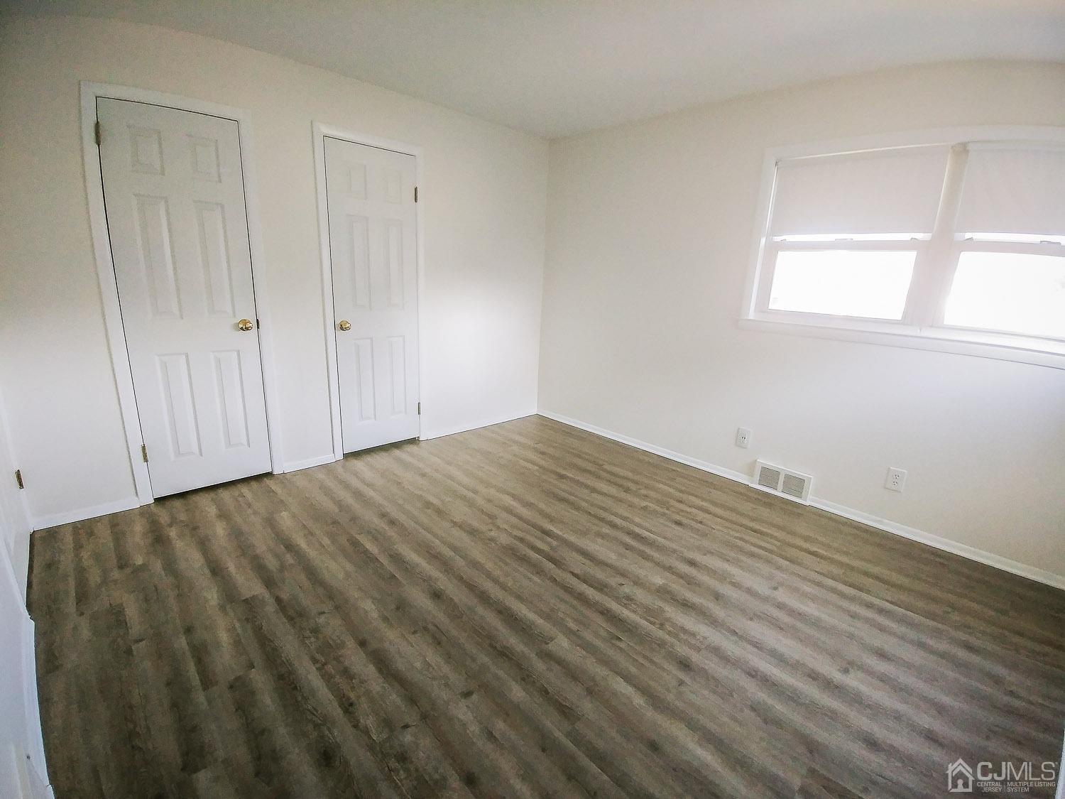 28 Longfield Road New Brunswick, NJ 08901 - Photo 4 of 14 a view of empty room with wooden floor