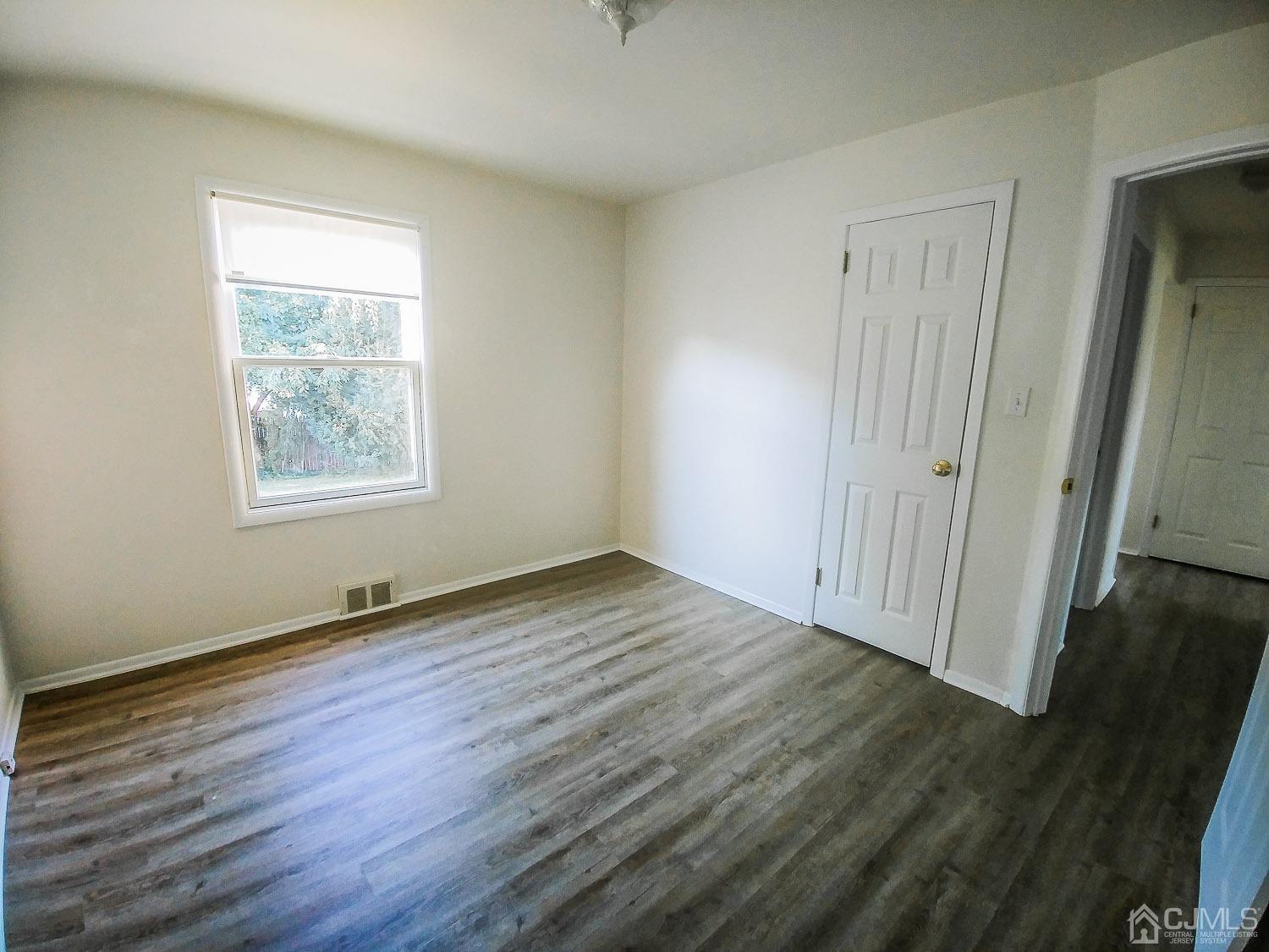 28 Longfield Road New Brunswick, NJ 08901 - Photo 5 of 14 a view of an empty room with wooden floor and a window
