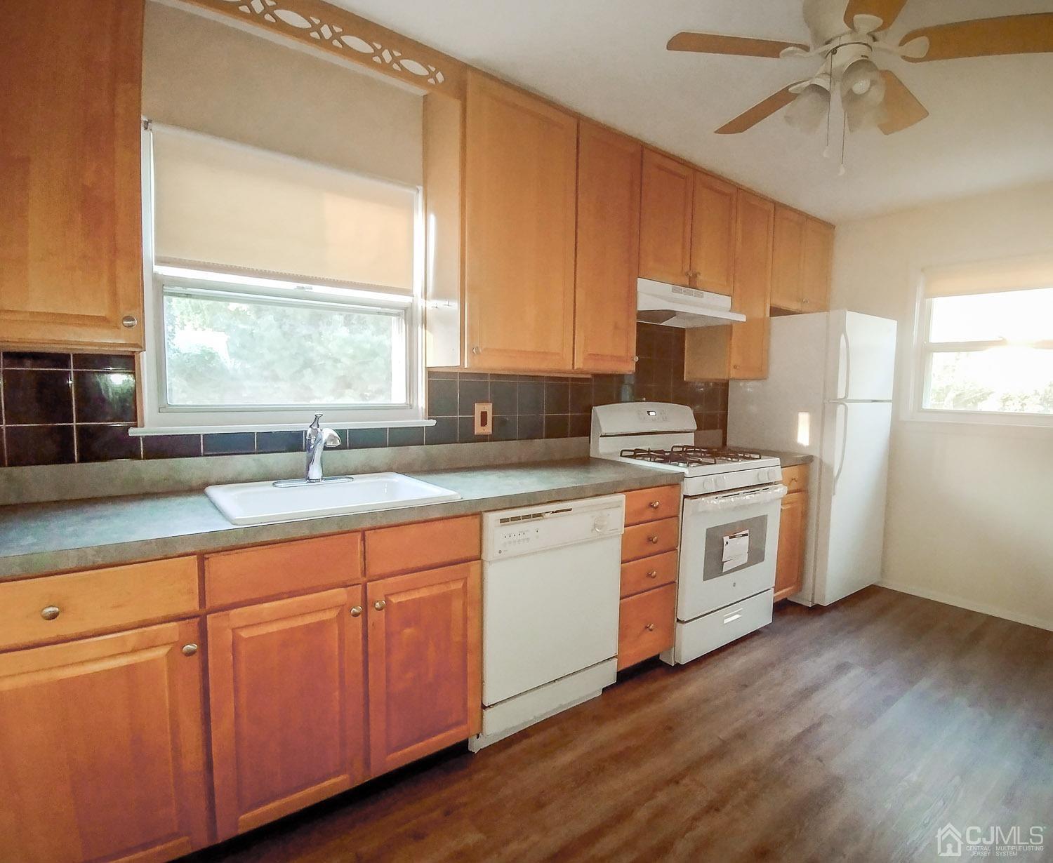 28 Longfield Road New Brunswick, NJ 08901 - Photo 7 of 14 a kitchen with stainless steel appliances white cabinets and a window