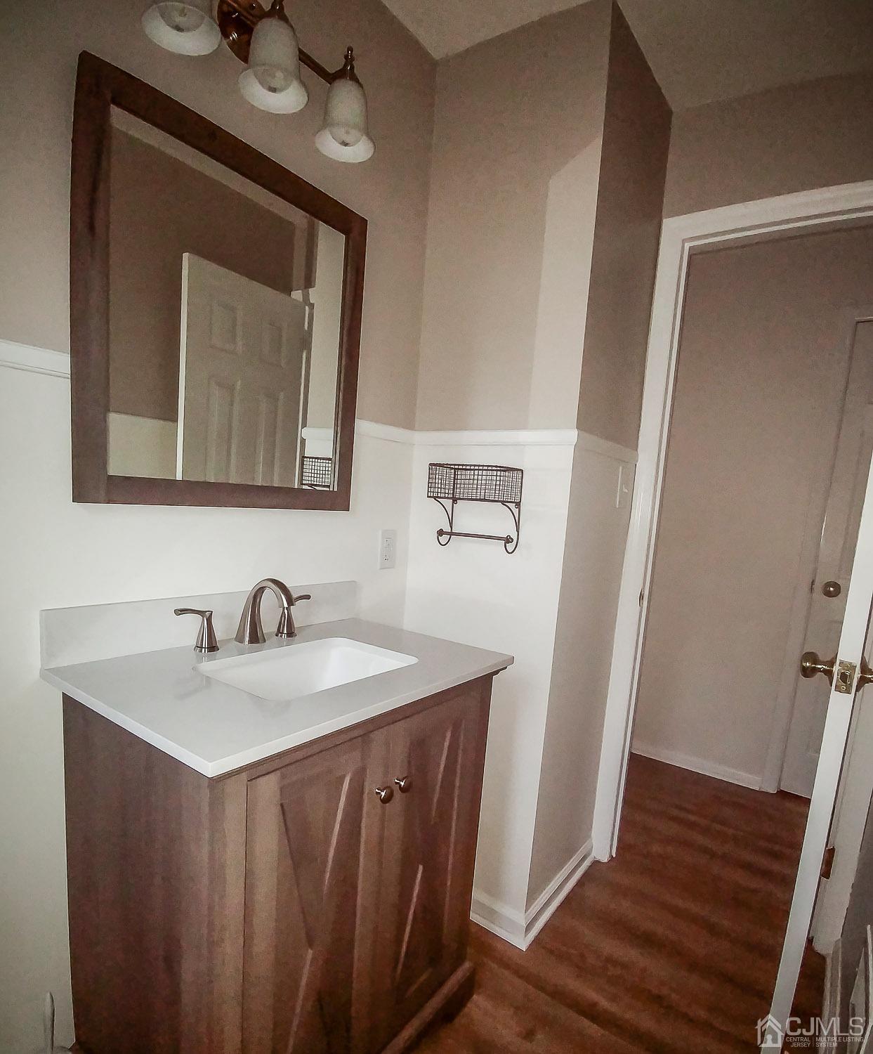 28 Longfield Road New Brunswick, NJ 08901 - Photo 8 of 14 a bathroom with a sink vanity and a mirror