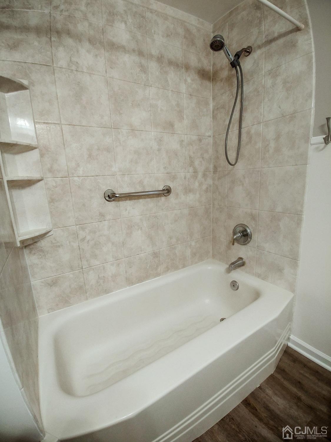 28 Longfield Road New Brunswick, NJ 08901 - Photo 9 of 14 a bathroom with a bath tub with a shower