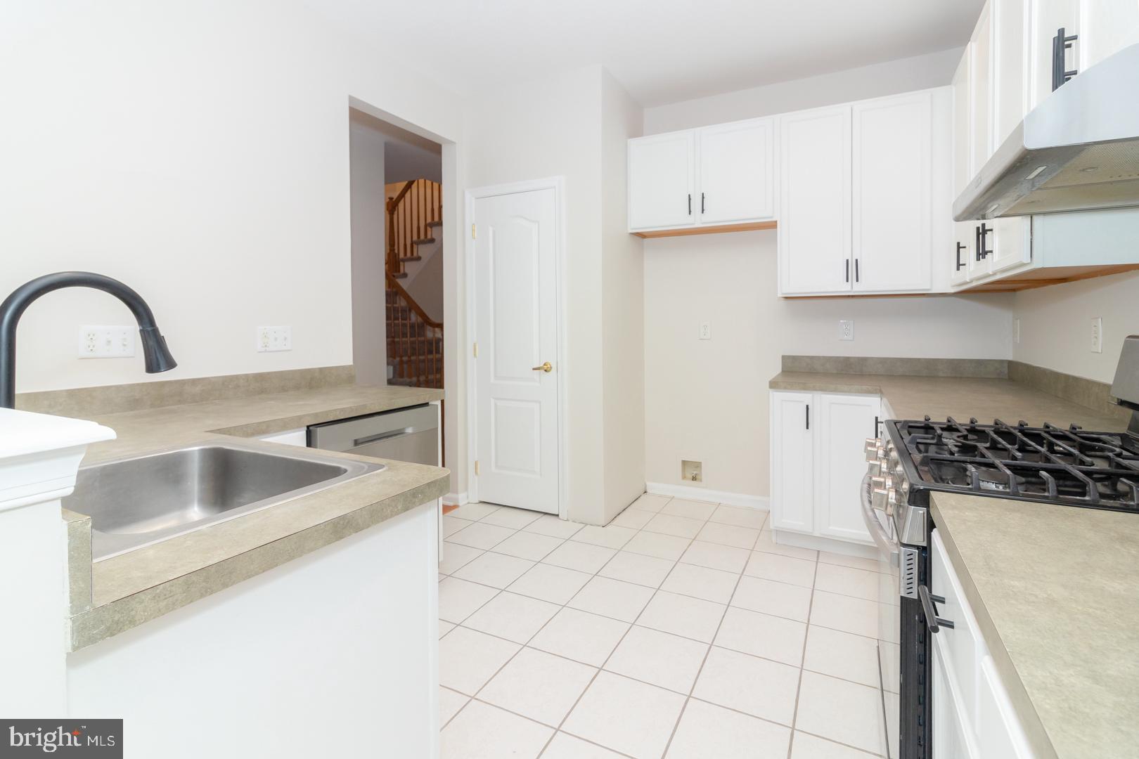 226 Hawthorne Way Riverside, NJ 08075 - Photo 11 of 32 a kitchen with granite countertop a sink a stove and cabinets