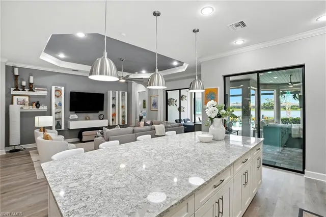 a large kitchen with kitchen island a large island in it