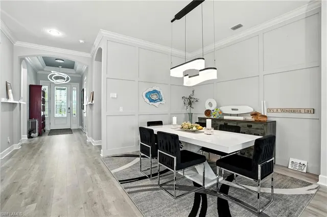 a view of a dining room with a table and chairs