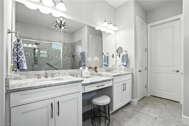 a bathroom with a granite countertop sink a toilet and a mirror