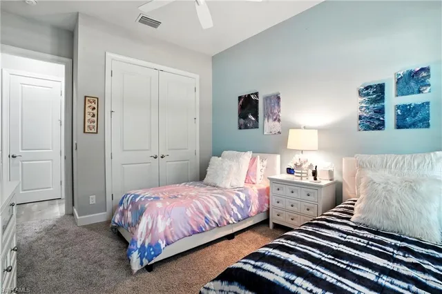 a bedroom with a bed and cabinets