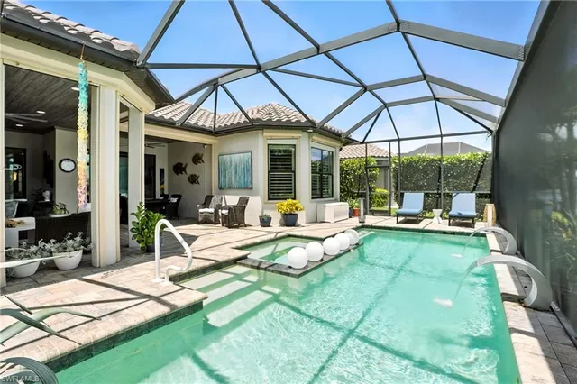 a view of a patio with dining table and chairs under an umbrella