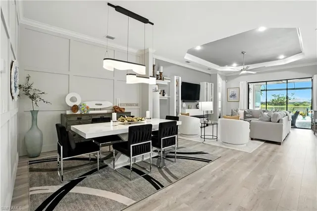 a living room with furniture and view of kitchen