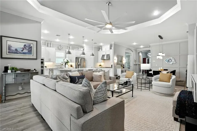 a living room with lots of furniture and a chandelier