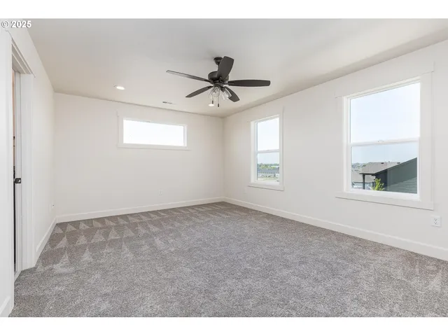 a view of a livingroom with a ceiling fan and window