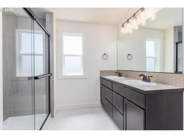 a bathroom with a sink a mirror and a shower
