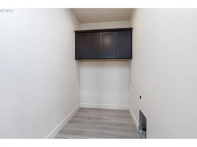 a view of kitchen cabinets and wooden floor