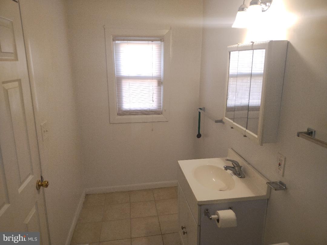 2608 Sansbury Road Upper Marlboro, MD 20774 - Photo 18 of 41 a bathroom with a sink toilet and vanity