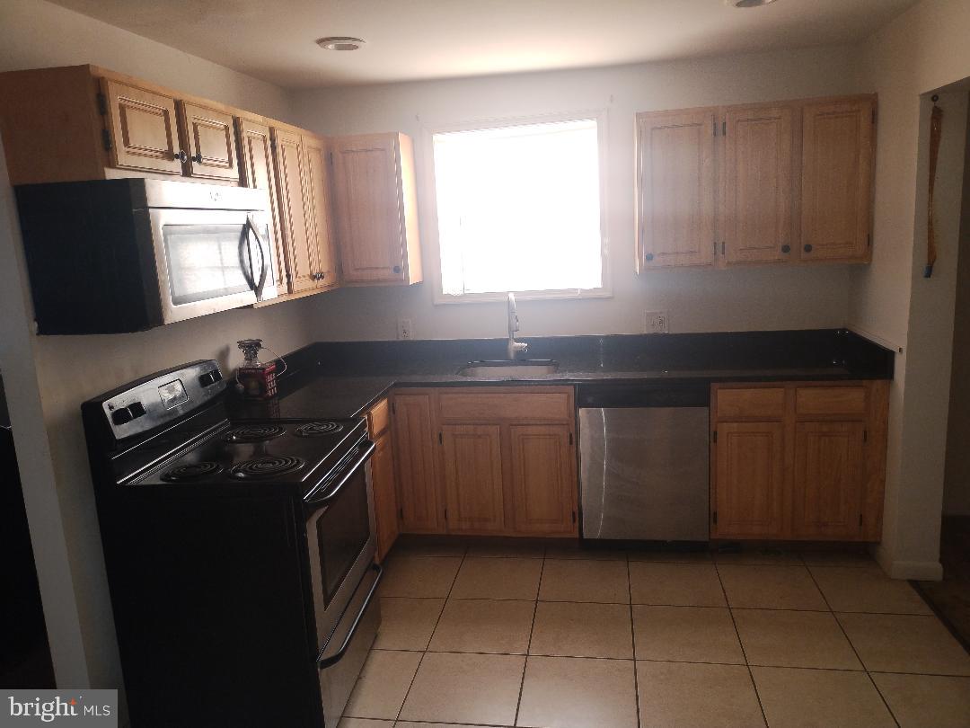2608 Sansbury Road Upper Marlboro, MD 20774 - Photo 21 of 41 a kitchen with a sink stove and microwave
