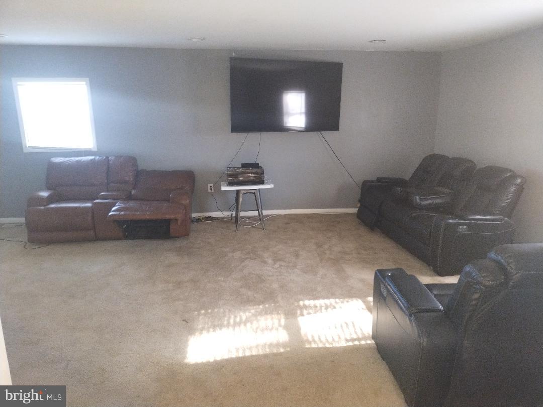 2608 Sansbury Road Upper Marlboro, MD 20774 - Photo 27 of 41 a living room with furniture and a flat screen tv