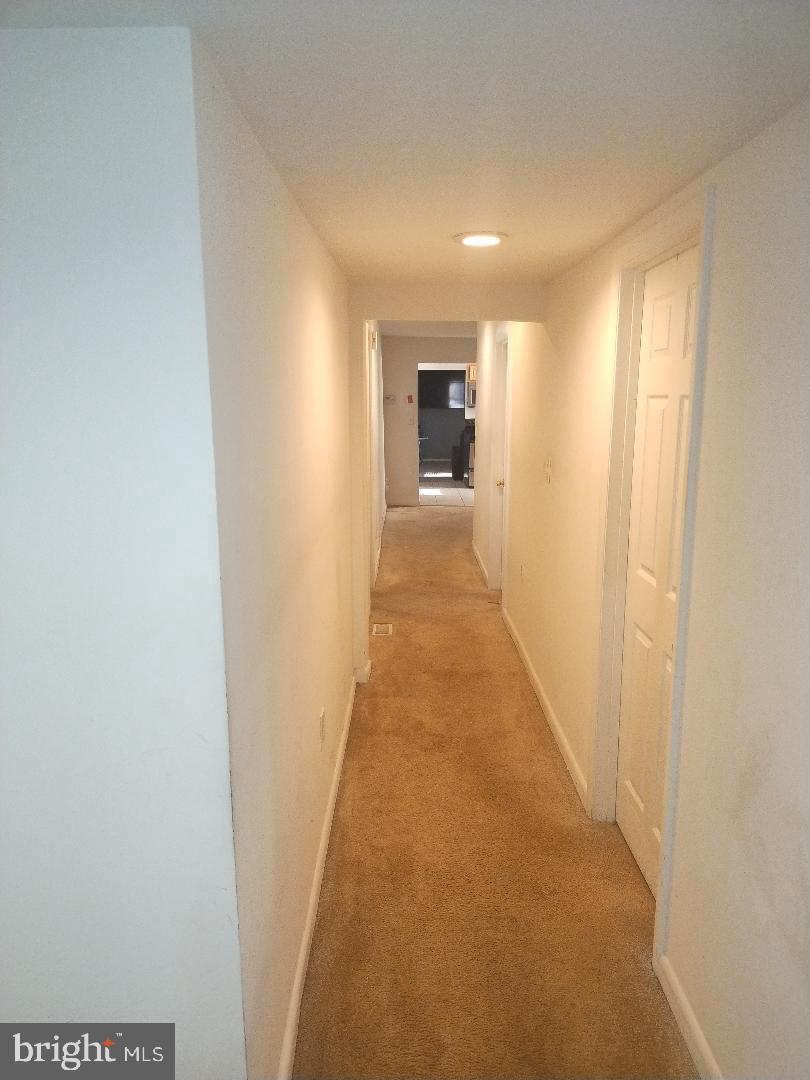 2608 Sansbury Road Upper Marlboro, MD 20774 - Photo 7 of 41 a view of a hallway with wooden floor