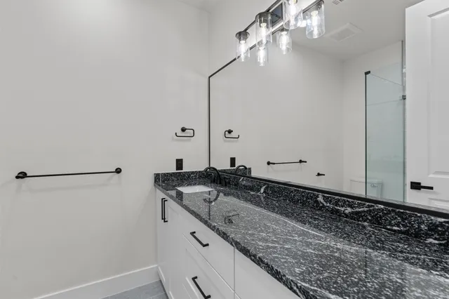 a view of a big room with wooden floor and windows