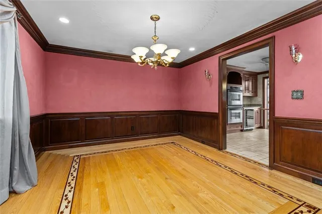 a kitchen with stainless steel appliances kitchen island granite countertop a refrigerator a oven and a sink with granite countertops