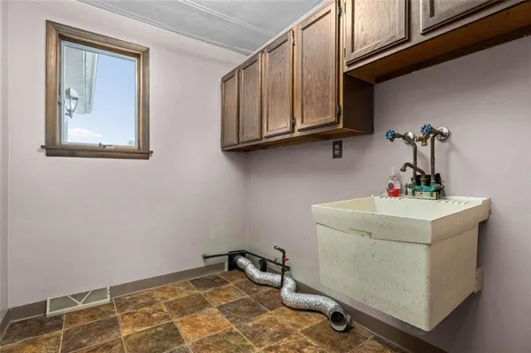 a view of a room with a ceiling fan and a window