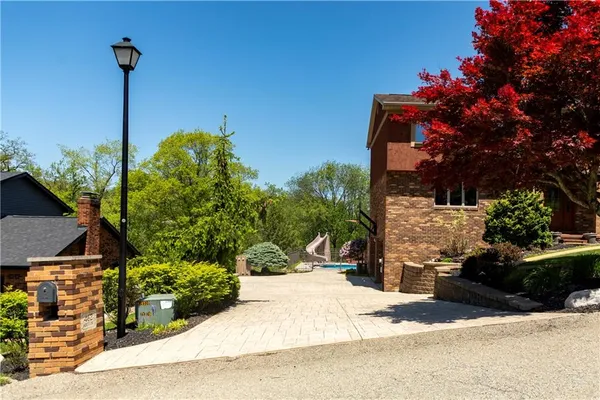 a view of a house with backyard and sitting area