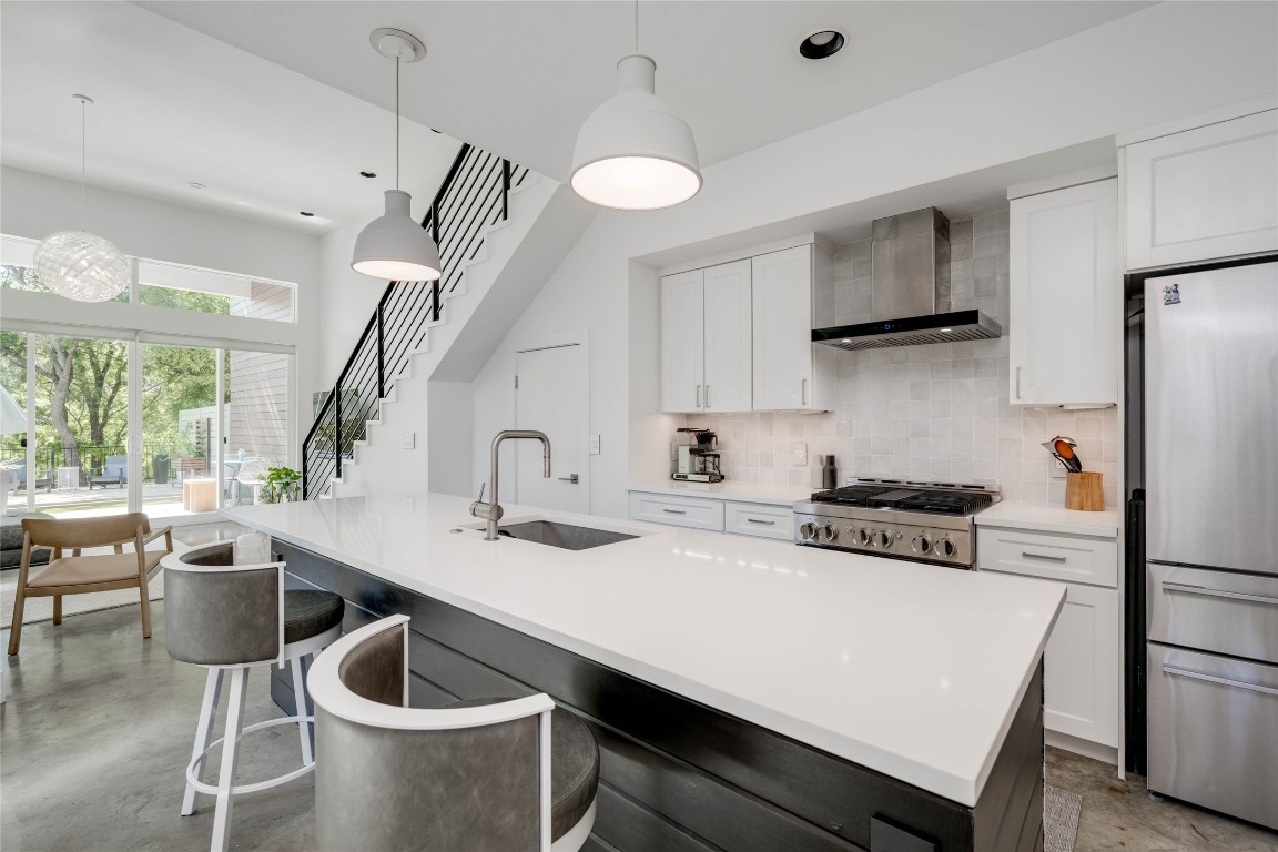 1179 Pandora Street, Unit A Austin, TX 78702 - Photo 1 of 1 a kitchen with a stove a refrigerator a sink a stove and white cabinets with wooden floor