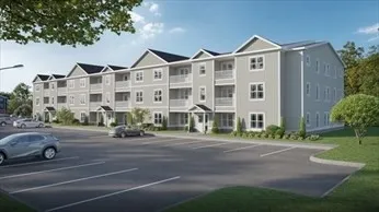 a view of a big house with wooden fence