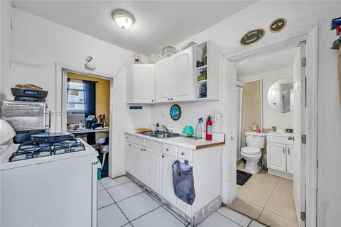 a kitchen with cabinets and window